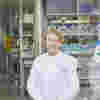 An image of a smiling Professor Ros Eeles, looking directly at the camera, wearing an ICR labcoat in a lab